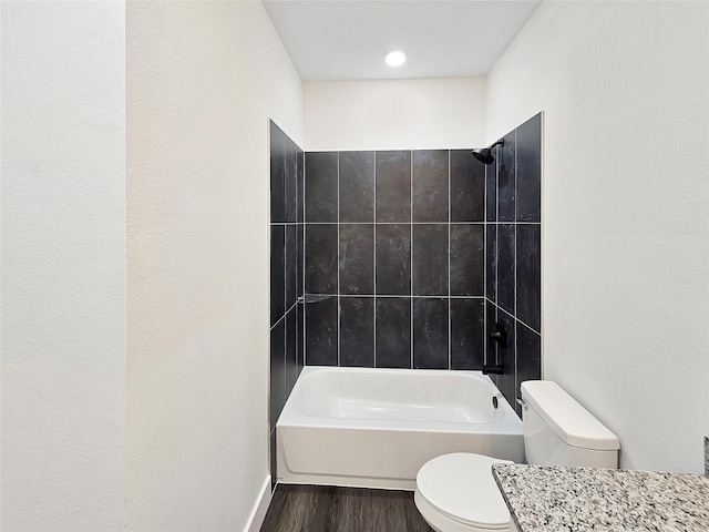 full bath with shower / tub combination, toilet, and wood finished floors