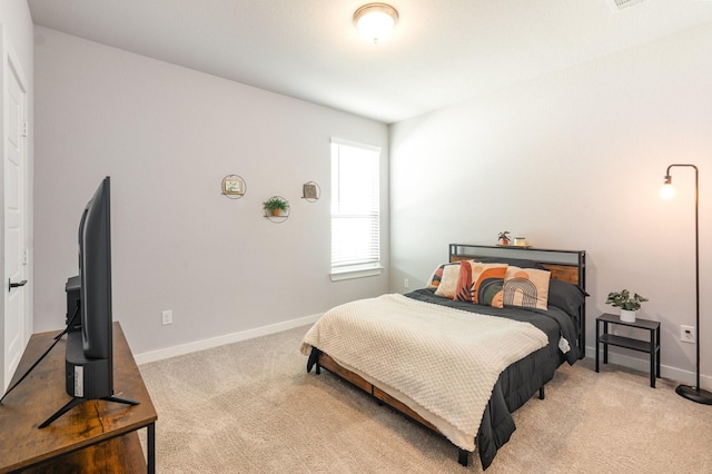 carpeted bedroom featuring baseboards