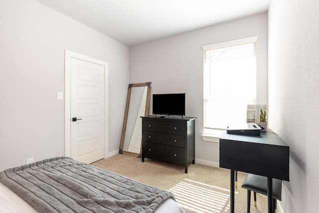 carpeted bedroom featuring baseboards