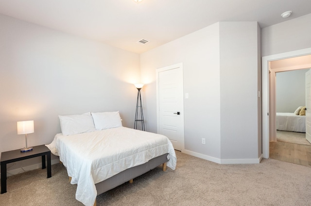 bedroom featuring carpet floors, baseboards, and visible vents