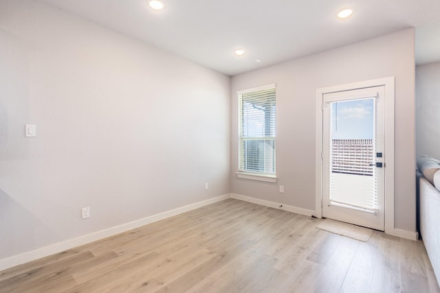 doorway to outside featuring light wood-style floors, recessed lighting, and baseboards