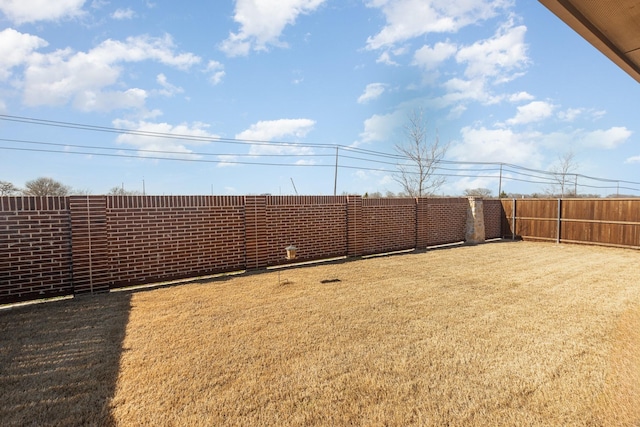 view of yard with a fenced backyard