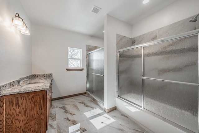 bathroom featuring marble finish floor, vanity, visible vents, and baseboards