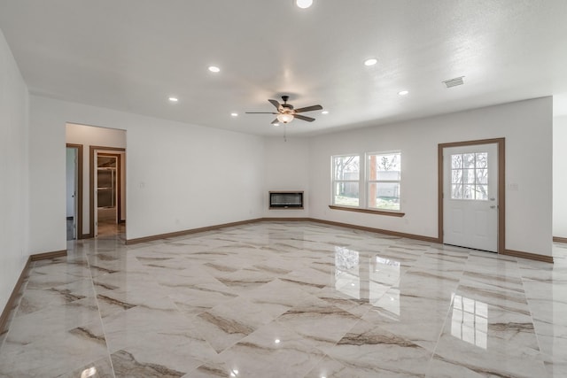 unfurnished living room featuring a glass covered fireplace, marble finish floor, visible vents, and baseboards