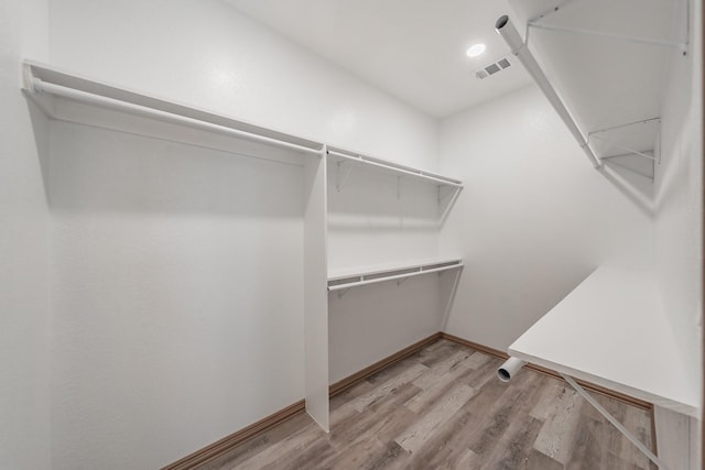 walk in closet with visible vents and light wood finished floors