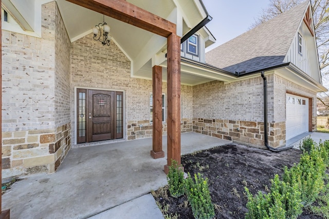 view of exterior entry featuring stone siding, a shingled roof, and brick siding