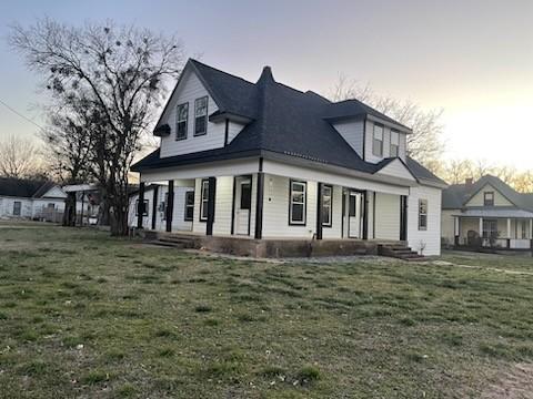 exterior space with a front yard and covered porch