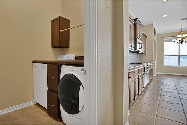 clothes washing area featuring cabinet space, visible vents, washer and dryer, a notable chandelier, and light tile patterned flooring