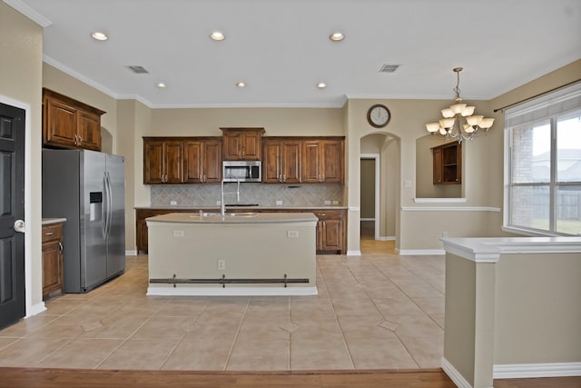 kitchen with stainless steel appliances, arched walkways, visible vents, and light tile patterned flooring