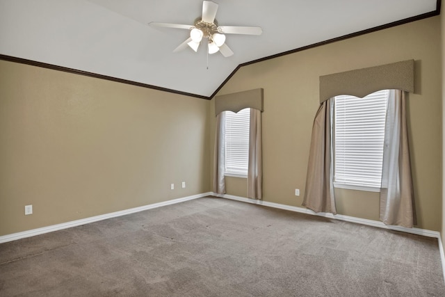 unfurnished room featuring baseboards, a ceiling fan, vaulted ceiling, crown molding, and carpet flooring