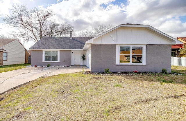 ranch-style home with brick siding, concrete driveway, an attached garage, a front yard, and fence