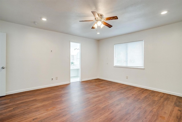 empty room with recessed lighting, wood finished floors, a ceiling fan, and baseboards