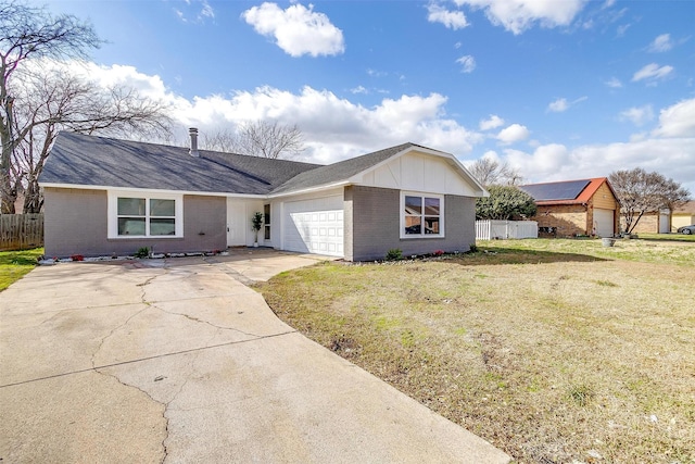 ranch-style house featuring an attached garage, brick siding, fence, concrete driveway, and a front lawn