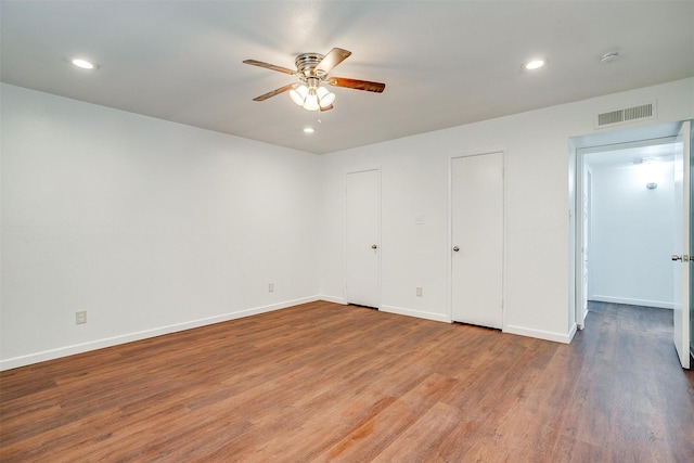 unfurnished bedroom featuring recessed lighting, visible vents, baseboards, and wood finished floors