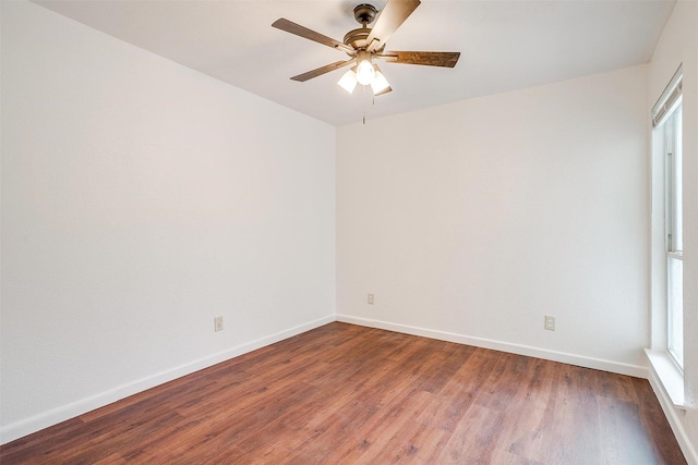 unfurnished room featuring a ceiling fan, baseboards, and wood finished floors