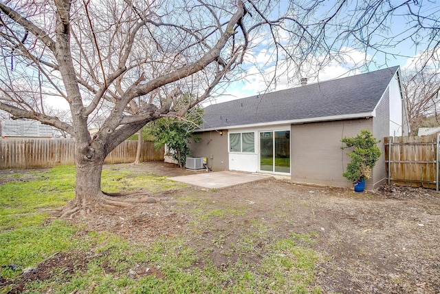 back of house with roof with shingles, brick siding, a patio, central AC unit, and a fenced backyard