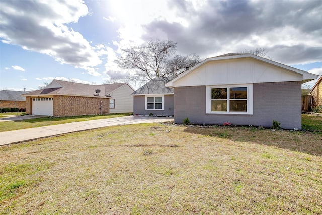 view of front of property with concrete driveway, brick siding, and a front lawn