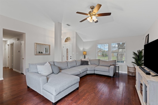 living area featuring baseboards, visible vents, ceiling fan, dark wood-type flooring, and vaulted ceiling