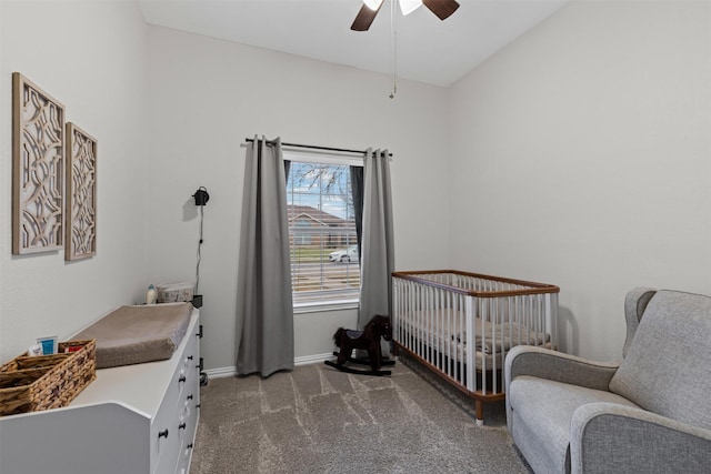 bedroom featuring a nursery area, carpet floors, ceiling fan, and baseboards