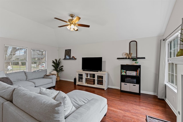 living area with lofted ceiling, ceiling fan, baseboards, and wood finished floors