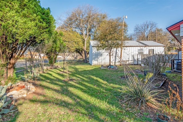 view of yard with fence and central AC