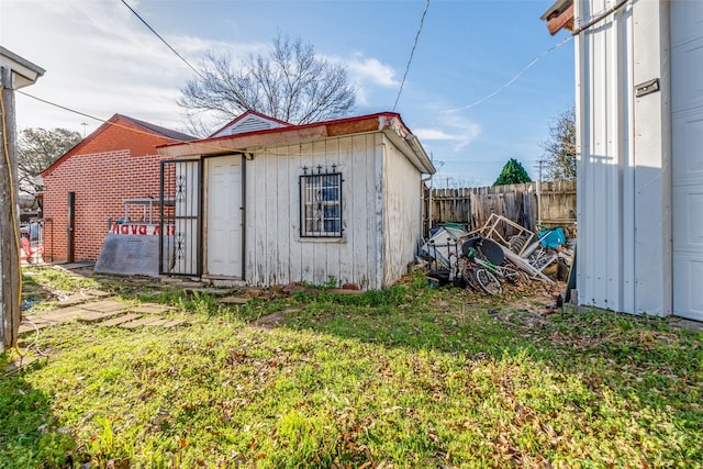 view of shed featuring fence