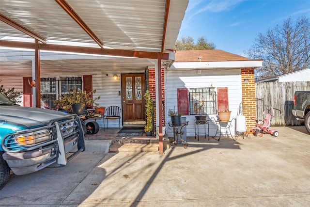 exterior space with french doors, brick siding, and fence