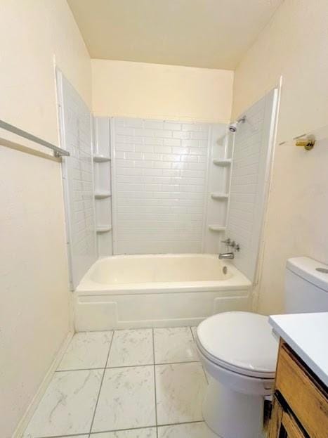 full bath featuring toilet, baseboards, shower / washtub combination, and vanity