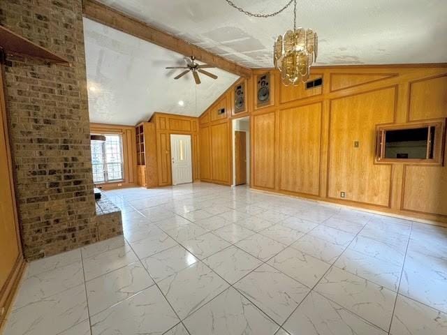 unfurnished living room with wooden walls, visible vents, vaulted ceiling with beams, marble finish floor, and ceiling fan with notable chandelier