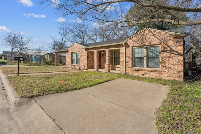 view of front facade with a front yard and brick siding