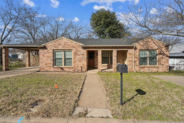 ranch-style home featuring a carport, a front yard, concrete driveway, and brick siding