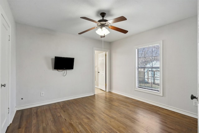 unfurnished living room featuring ceiling fan, baseboards, and wood finished floors