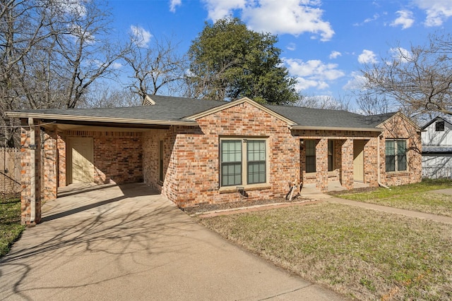 ranch-style house featuring driveway, brick siding, roof with shingles, and a front yard