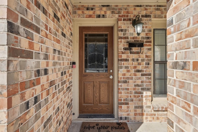 property entrance with brick siding