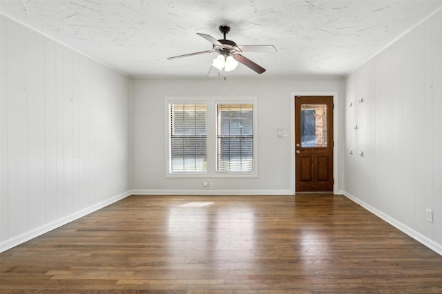 entrance foyer with a ceiling fan, ornamental molding, baseboards, and wood finished floors