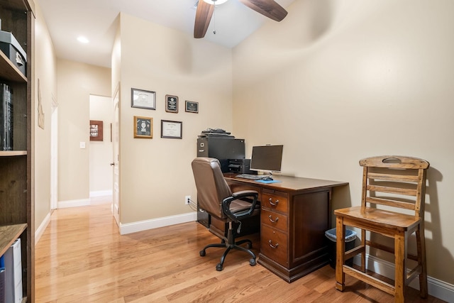 office area featuring light wood-style floors, ceiling fan, and baseboards