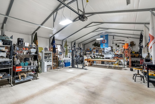 garage with a workshop area and a garage door opener