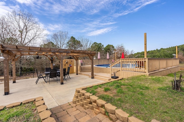 view of patio / terrace with outdoor dining space, fence, a fenced in pool, and a pergola