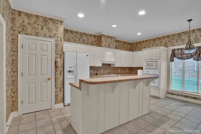 kitchen featuring light tile patterned floors, light countertops, custom exhaust hood, and white appliances