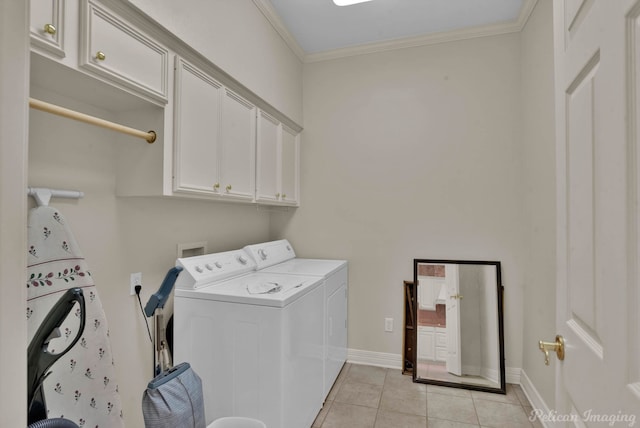 laundry room with light tile patterned floors, baseboards, cabinet space, washer and clothes dryer, and crown molding