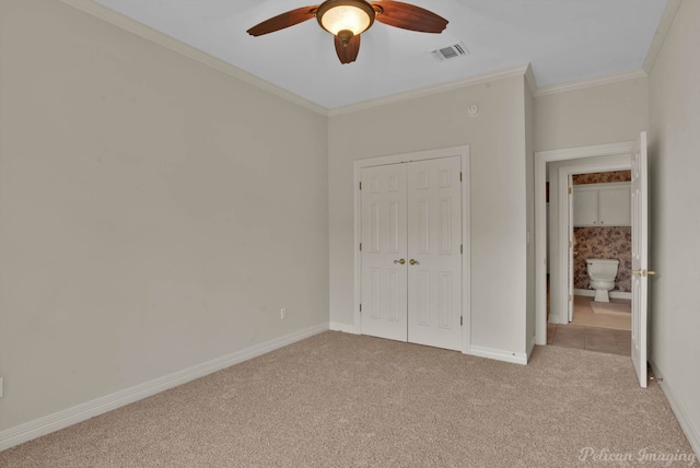 unfurnished bedroom featuring visible vents, crown molding, light carpet, and baseboards