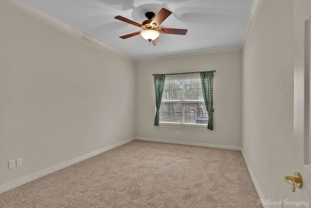 empty room with ornamental molding, carpet, a ceiling fan, and baseboards