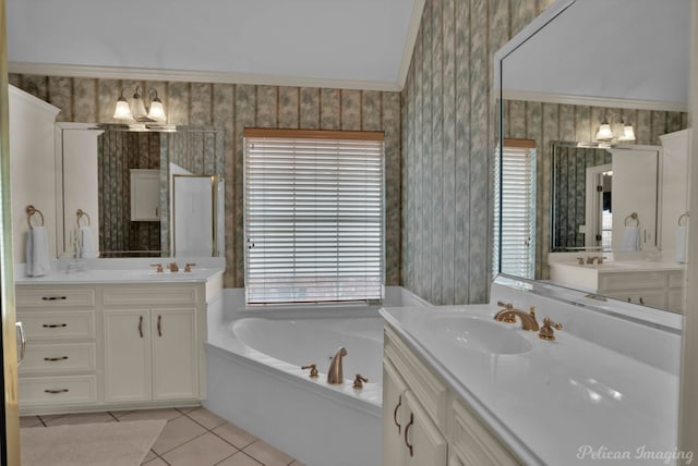 bathroom featuring tile patterned flooring, a garden tub, wallpapered walls, two vanities, and a sink