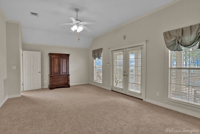 unfurnished room featuring light carpet, french doors, lofted ceiling, and ornamental molding