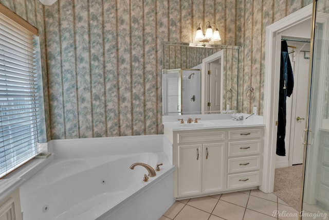 full bathroom featuring a tub with jets, tile patterned floors, vanity, and wallpapered walls