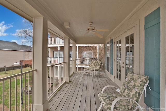 wooden terrace featuring a ceiling fan