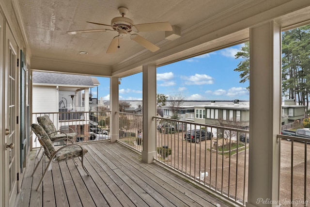 wooden deck featuring ceiling fan and a residential view