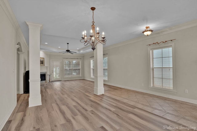 unfurnished living room with ornamental molding, light wood-type flooring, and ornate columns