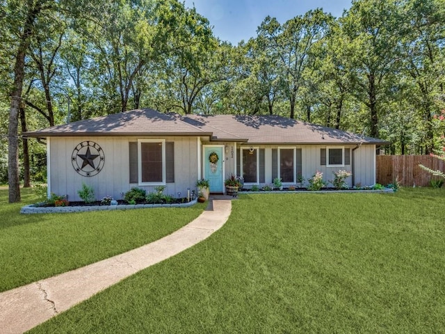 ranch-style home featuring a front yard and fence