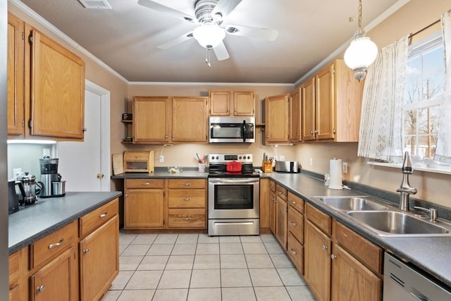 kitchen with dark countertops, appliances with stainless steel finishes, a ceiling fan, ornamental molding, and a sink